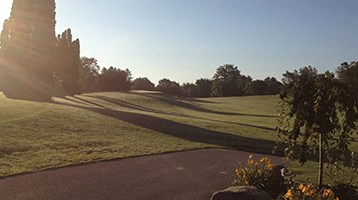 view of the golf course hole at sunset